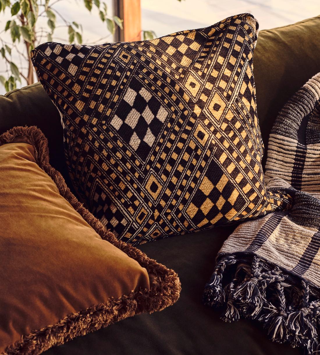 Pierre Frey Djbouti Cushion - Black and Gold - Lifestyle - Image 1