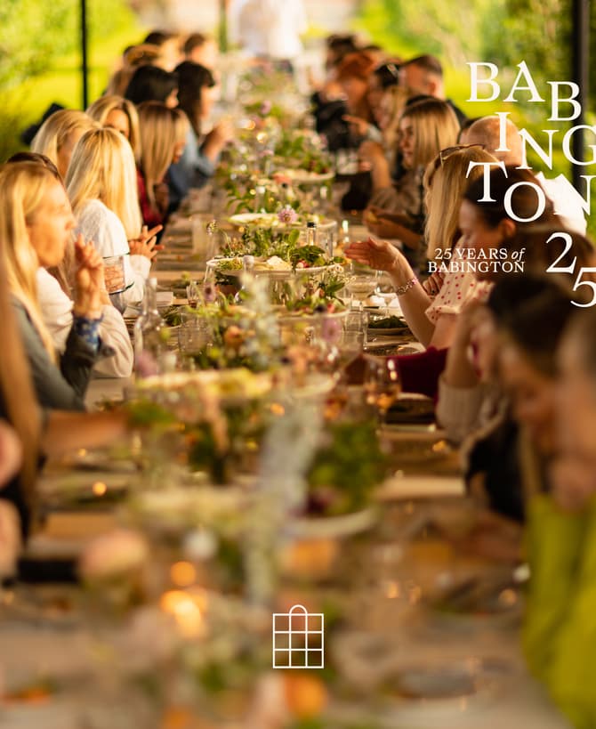 Guests seated at a long, outdoor, elegantly set table enjoy a meal amid lush greenery. Overlay text reads: "BABINGTON 25 YEARS of BABINGTON 25."